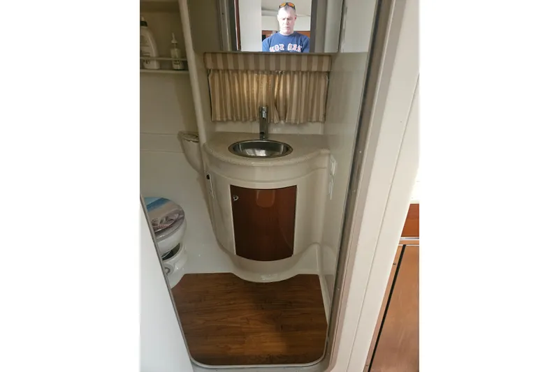 Slide: The Image of 2010 Formula 34 Performance Cruiser bathroom with sink, mirror, and wooden flooring. - 17