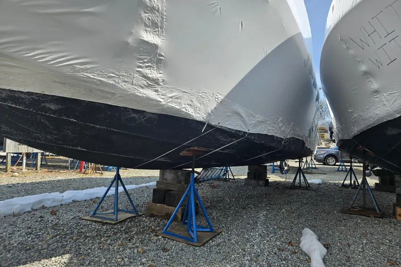 Slide: The Image of 2010 Formula 34 Performance Cruiser boats in winter storage, covered and supported on stands. - 19