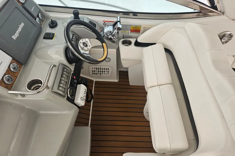Slide: The Image of 2010 Formula 34 Performance Cruiser helm with steering wheel and navigation controls. - 26