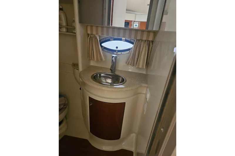Slide: The Image of 2010 Formula 34 Performance Cruiser bathroom with sink and porthole window. - 32