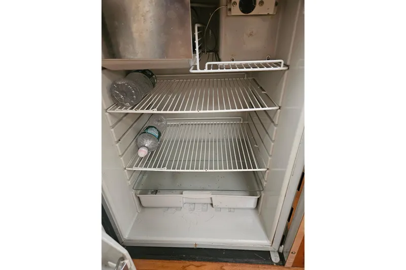 Slide: The Image of Open refrigerator with water bottles inside, part of a 2010 Formula 34 Performance Cruiser. - 35