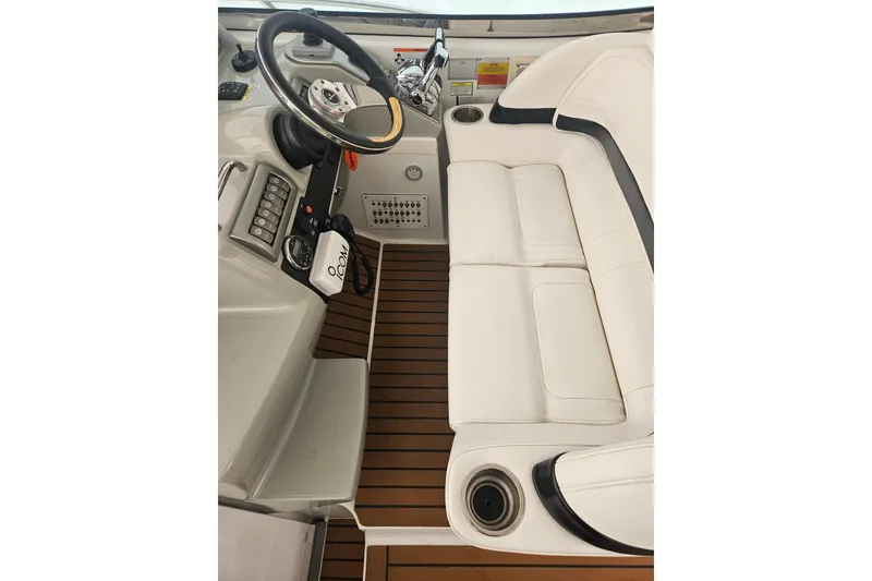Slide: The Image of 2010 Formula 34 Performance Cruiser helm with white seating and wood-style flooring. - 43