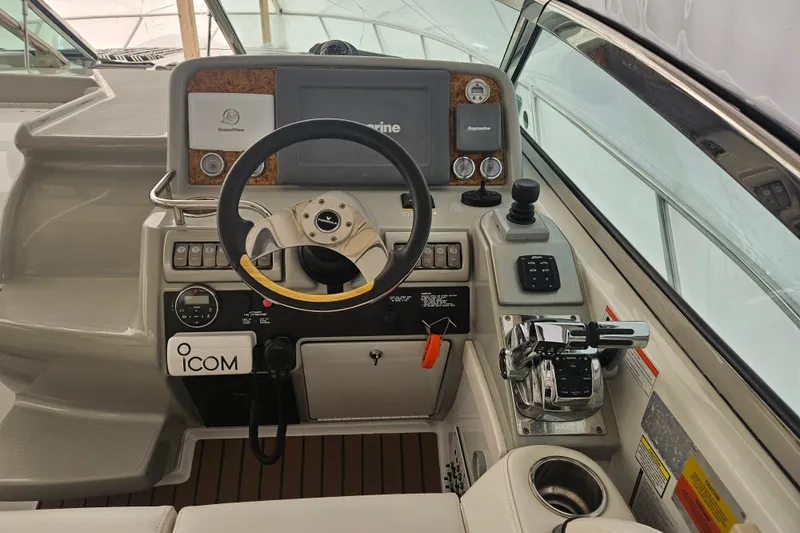 Slide: The Image of 2010 Formula 34 Performance Cruiser helm with steering wheel and navigation controls. - 50