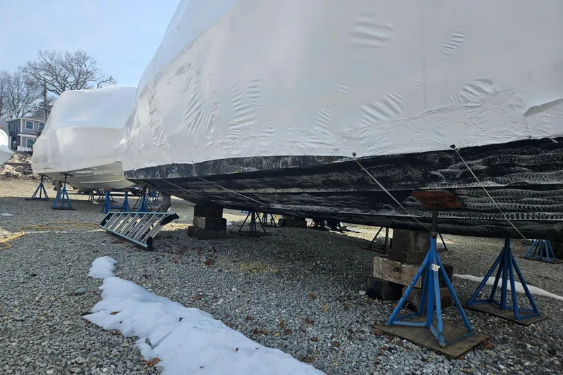 Slide: The Image of 2010 Formula 34 Performance Cruiser in winter storage, covered and elevated on stands. - 51