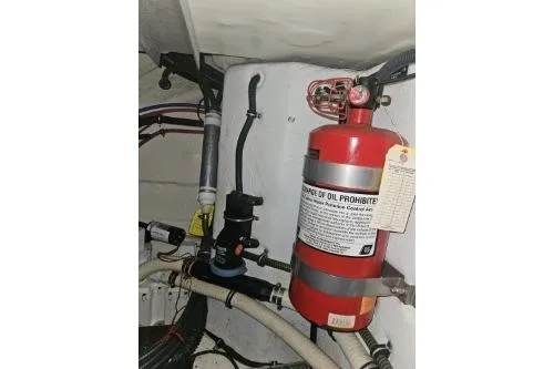 Slide: The Image of 2010 Formula 34 Performance Cruiser engine room with fire extinguisher and hoses. - 63