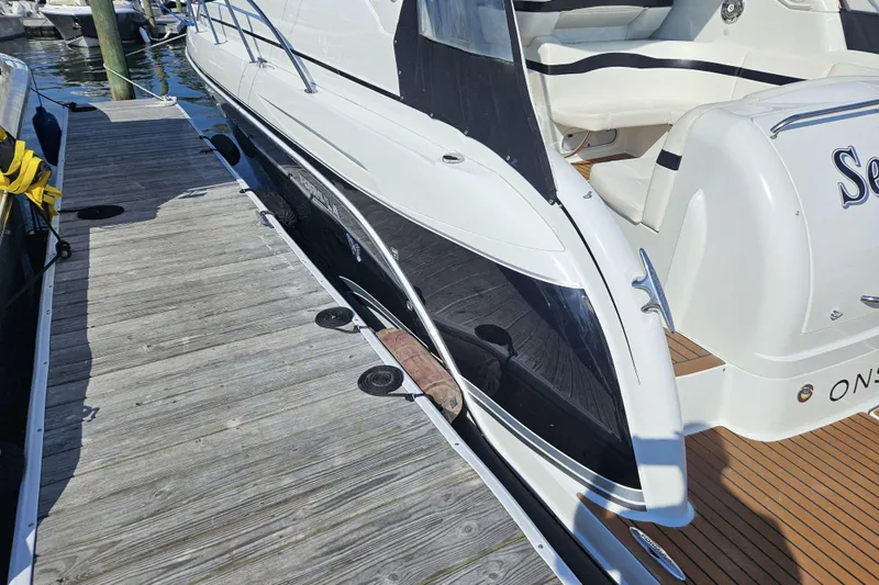 Slide: The Image of 2010 Formula 34 Performance Cruiser docked at marina, showcasing sleek design and luxury features. - 7