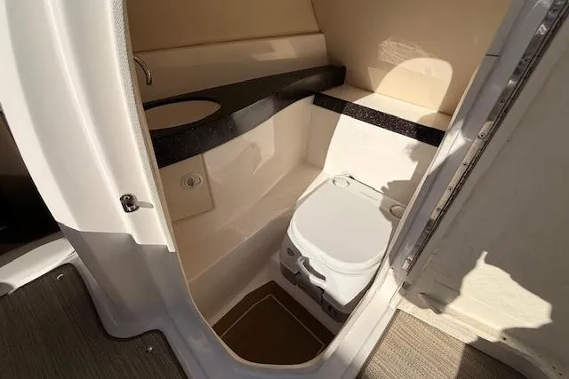 Slide: The Image of 2013 Regal 2500 Bowrider boat interior with compact bathroom and toilet. - 12