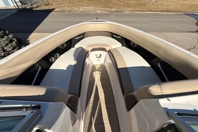 Slide: The Image of 2013 Regal 2500 Bowrider interior with beige seating and cup holders. - 15