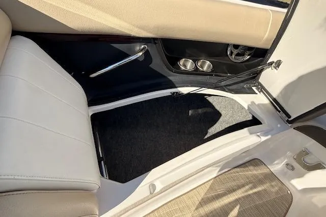 Slide: The Image of 2013 Regal 2500 Bowrider interior with beige seating and storage compartment. - 16