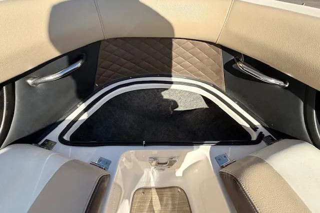 Slide: The Image of 2013 Regal 2500 Bowrider interior with tan seating and storage compartment. - 17