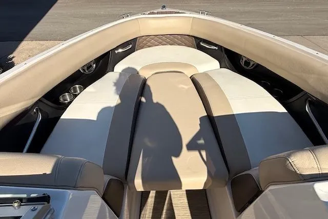 Slide: The Image of 2013 Regal 2500 Bowrider interior with beige and white seating, shadow visible. - 19