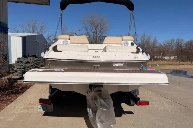 Slide: The Image of 2013 Regal 2500 Bowrider boat on trailer, rear view, outdoor setting. - 2