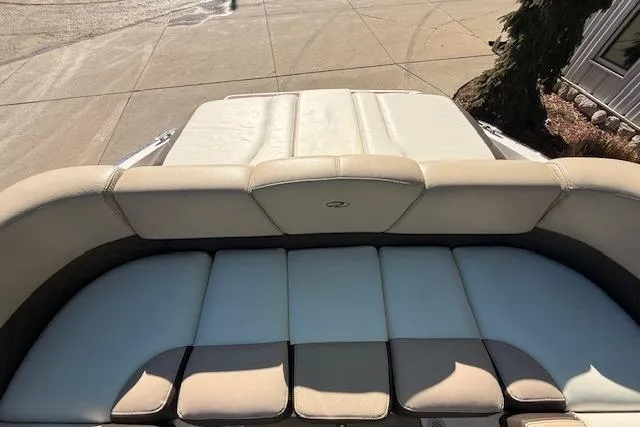 Slide: The Image of 2013 Regal 2500 Bowrider boat with beige and white cushioned seating. - 22