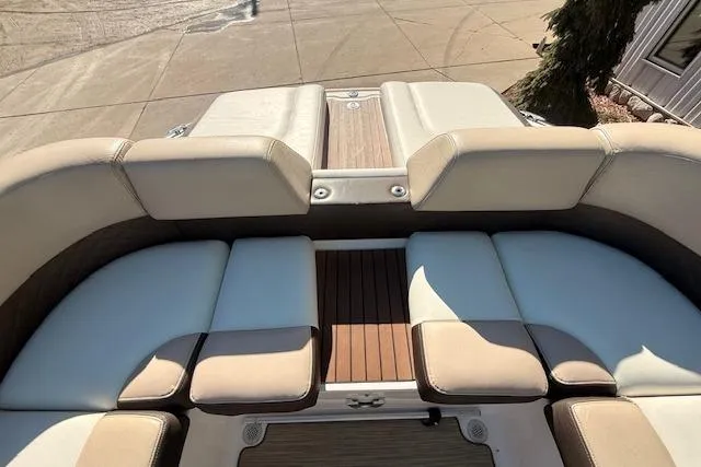 Slide: The Image of 2013 Regal 2500 Bowrider boat interior with cushioned seating and wood accents. - 24