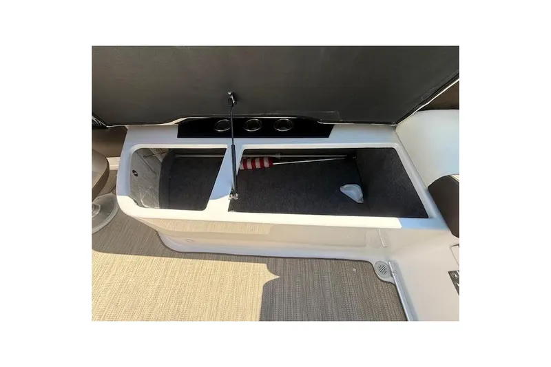 Slide: The Image of 2013 Regal 2500 Bowrider storage compartment with carpeted interior and cup holders. - 25