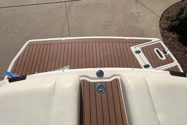 Slide: The Image of 2013 Regal 2500 Bowrider boat with teak swim platform and white upholstery. - 28