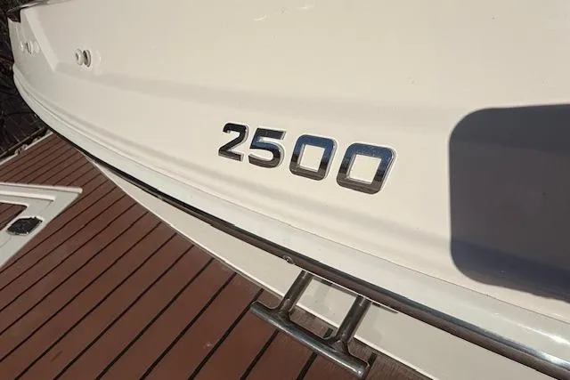 Slide: The Image of 2013 Regal 2500 Bowrider boat, white hull with model number on deck. - 29