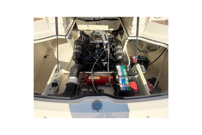 Slide: The Image of 2013 Regal 2500 Bowrider engine compartment with visible components and batteries. - 30