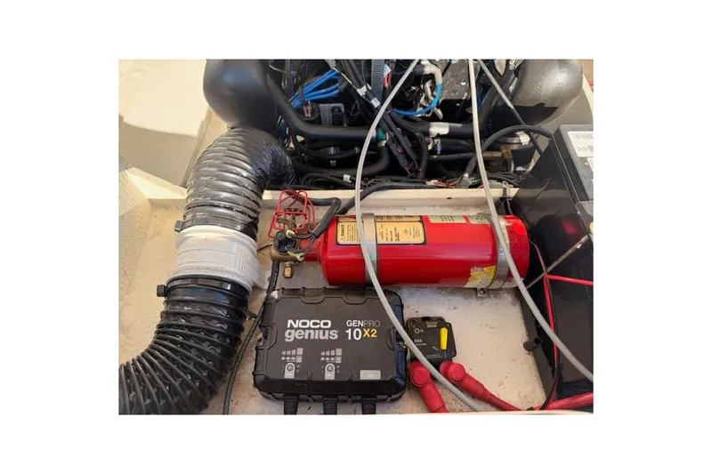 Slide: The Image of Engine compartment of 2013 Regal 2500 Bowrider with NOCO Genius charger and fire extinguisher. - 33