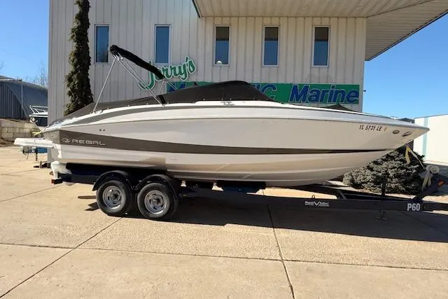 Slide: The Image of 2013 Regal 2500 Bowrider boat on trailer outside marine shop. - 37