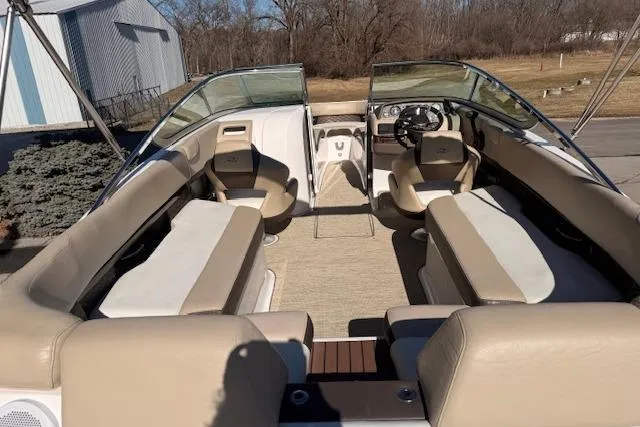 Slide: The Image of 2013 Regal 2500 Bowrider boat interior with beige seating and steering wheel. - 4