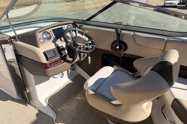 Slide: The Image of 2013 Regal 2500 Bowrider cockpit with steering wheel and control panel. - 5