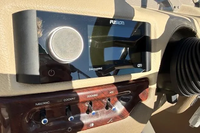 Slide: The Image of Fusion stereo system on 2013 Regal 2500 Bowrider dashboard with control switches. - 7