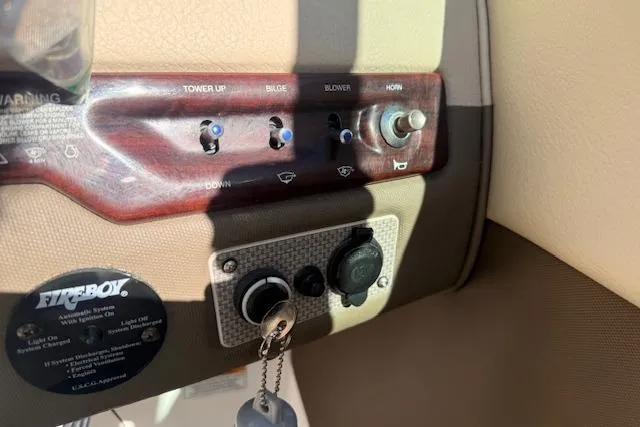 Slide: The Image of Control panel of a 2013 Regal 2500 Bowrider boat with switches and ignition. - 8