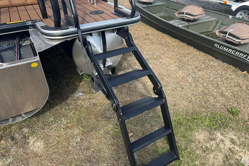 Slide: The Image of 2026 Bentley Pontoons Elite 253 Tritoon with ladder on grassy area. - 10