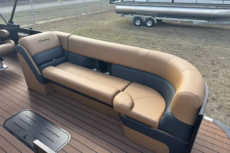 Slide: The Image of 2026 Bentley Pontoons Elite 253 Swingback interior with tan and gray seating on deck. - 11