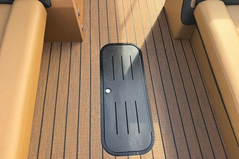 Slide: The Image of 2026 Bentley Pontoons Elite 253 interior with tan seating and sleek flooring design. - 17