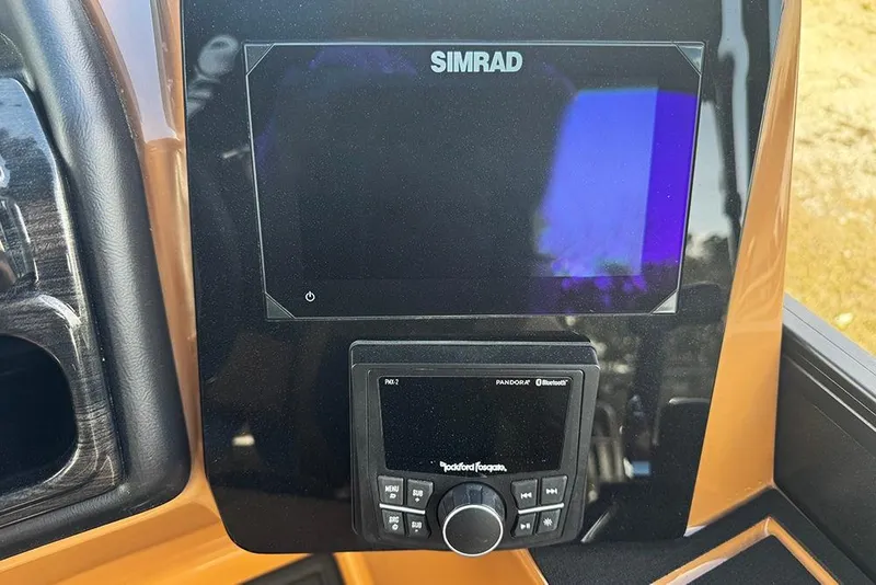 Slide: The Image of 2026 Bentley Pontoons Elite 253 dashboard with Simrad and Rockford Fosgate controls. - 22