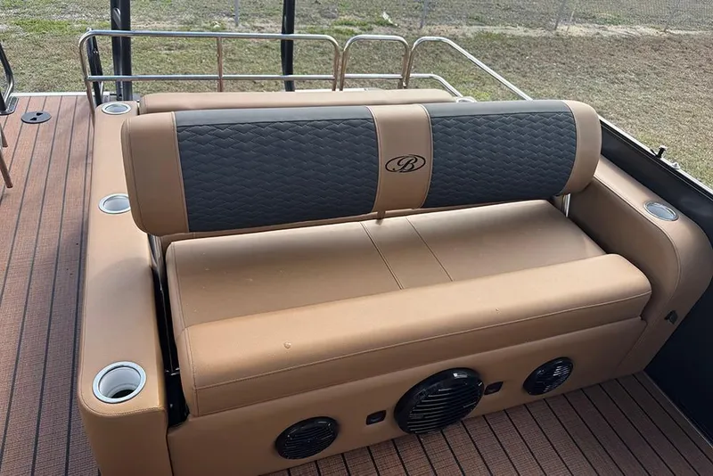 Slide: The Image of 2026 Bentley Pontoons Elite 253 Swingback Dual Captain Full Tritoon seating with cup holders and speakers. - 26
