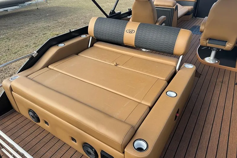 Slide: The Image of 2026 Bentley Pontoons Elite 253 Swingback interior with tan leather seating and cup holders. - 29