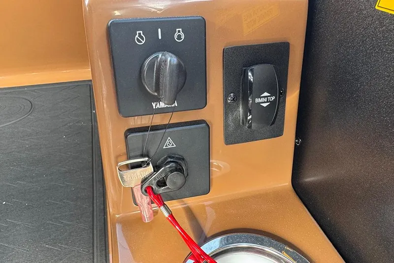 Slide: The Image of Control panel of 2026 Bentley Pontoons Elite 253 Swingback Tritoon with ignition and Bimini top switch. - 34