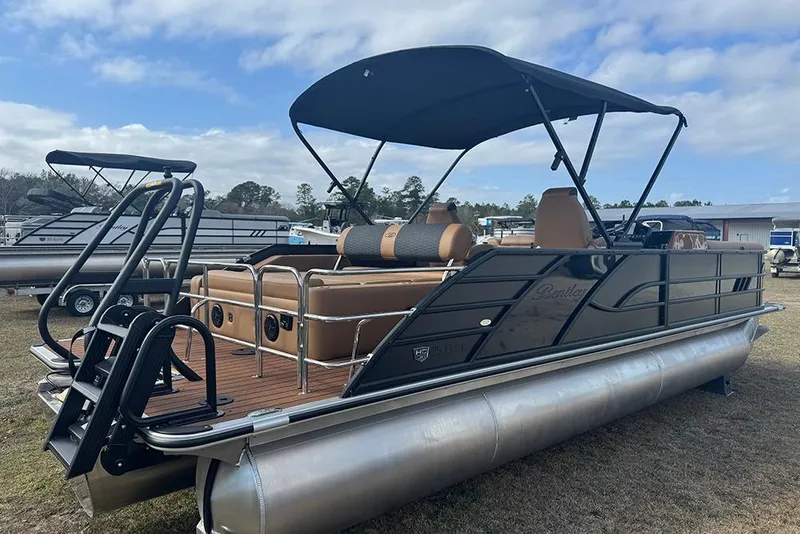 Slide: The Image of 2026 Bentley Pontoons Elite 253 Swingback Dual Captain Full Tritoon on display outdoors. - 5