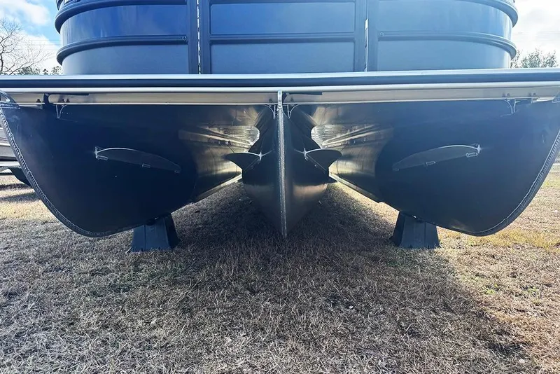 Slide: The Image of 2026 Bentley Pontoons Elite 253 Swingback Dual Captain Full Tritoon, underside view on grass. - 8