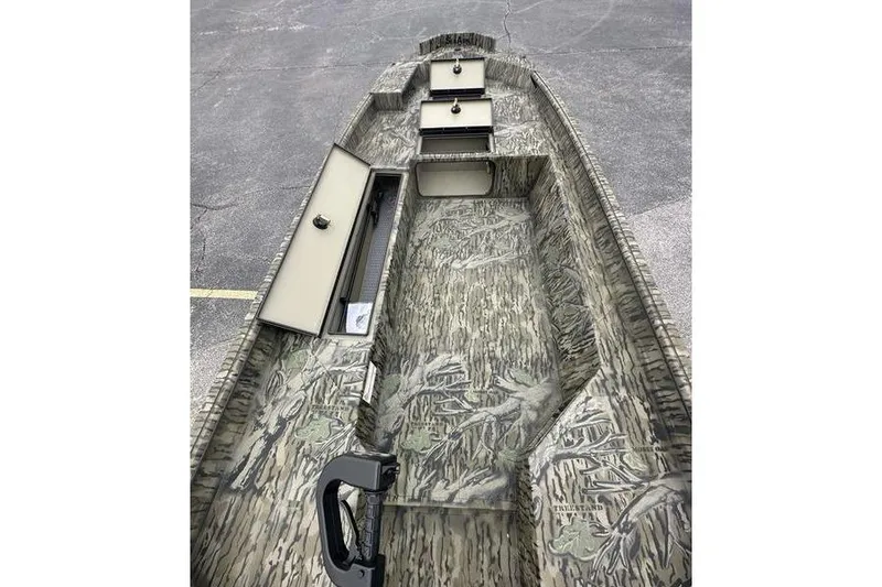 Slide: The Image of 2026 SeaArk 1752 Slayer X boat interior with camouflage design and storage compartments. - 2