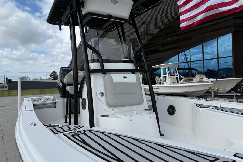 Slide: The Image of 2018 Sea Pro 228 Bay boat with T-top, displayed outdoors near other boats. - 11
