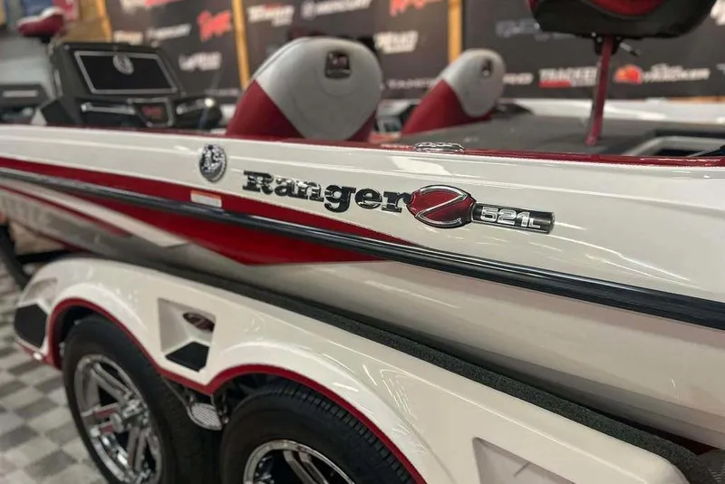 Slide: The Image of 2021 Ranger Z521L boat with red and white design, showcased indoors. - 4