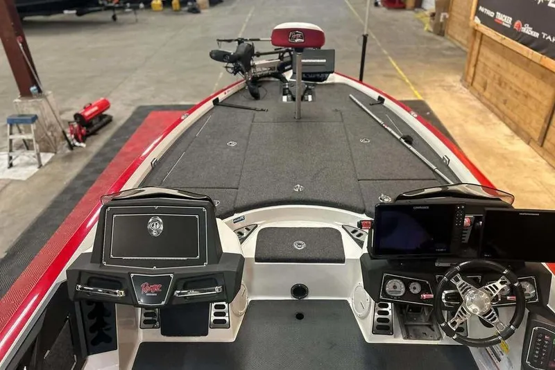 Slide: The Image of 2021 Ranger Z521L boat interior with advanced navigation and control systems in a garage setting. - 6