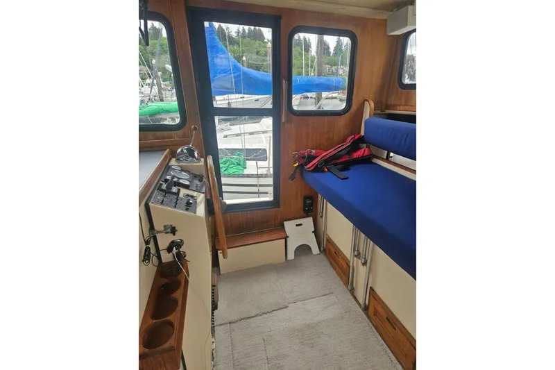 Slide: The Image of Interior of a 1998 Nordic Tug 32 boat with seating and control panel. - 11