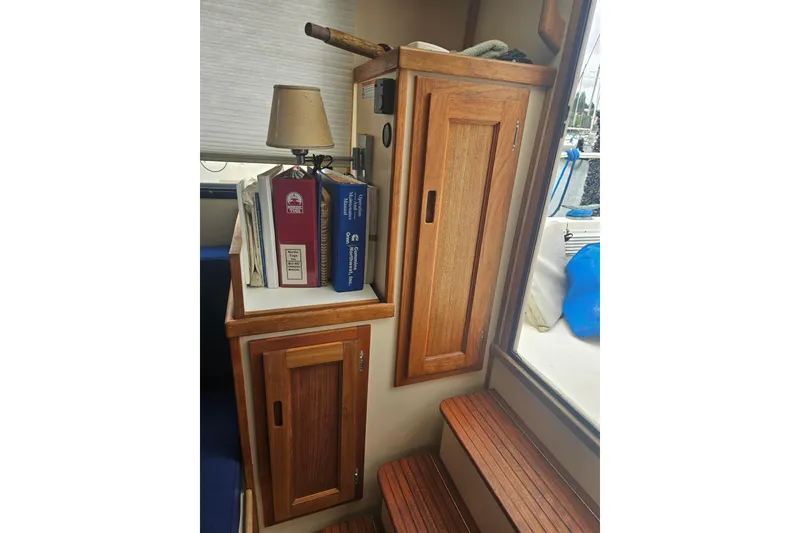 Slide: The Image of Interior of 1998 Nordic Tug 32 with wooden cabinets and nautical decor. - 14