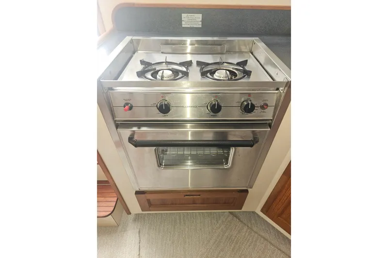 Slide: The Image of Stainless steel stove and oven in a 1998 Nordic Tug 32 boat kitchen. - 18