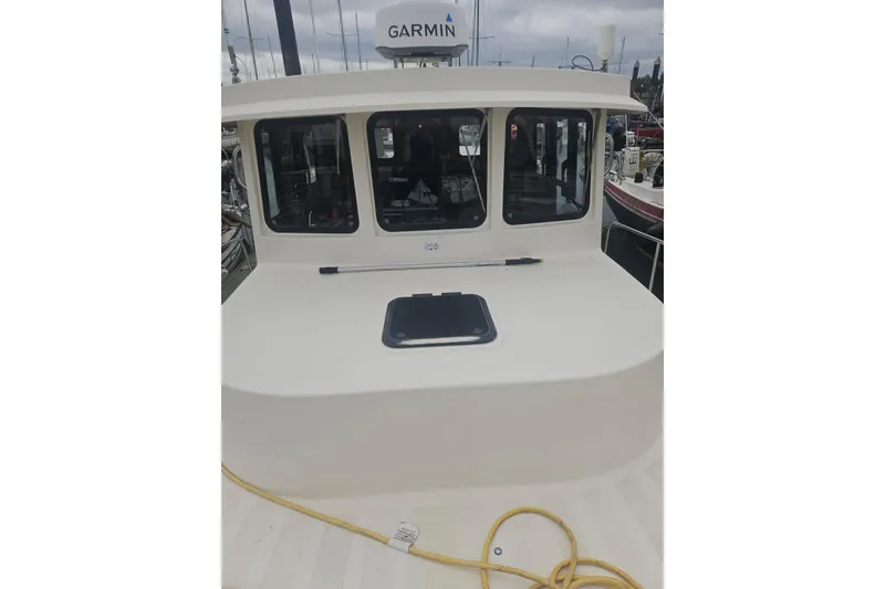 Slide: The Image of 1998 Nordic Tug 32 boat with Garmin equipment, docked at a marina. - 2