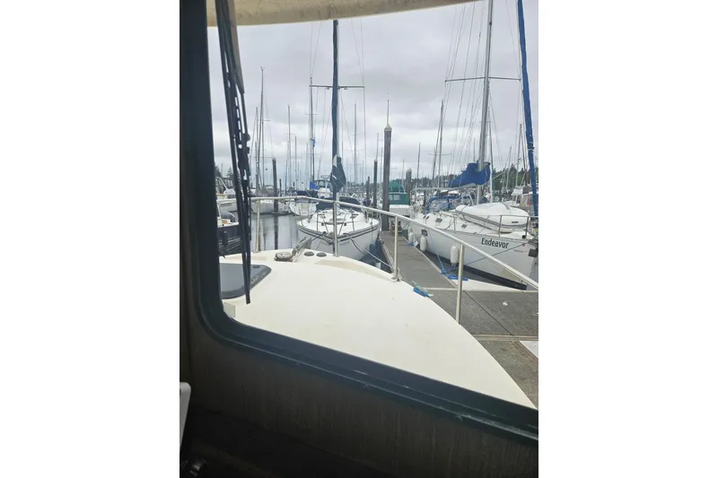 Slide: The Image of View from a 1998 Nordic Tug 32, docked among sailboats in a marina. - 25