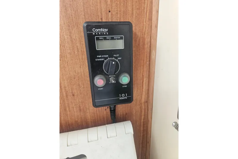 Slide: The Image of ComNav Marine control panel on 1998 Nordic Tug 32 boat, mounted on wooden surface. - 31