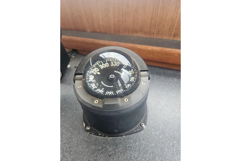 Slide: The Image of Compass on 1998 Nordic Tug 32 boat dashboard, displaying navigational directions. - 32