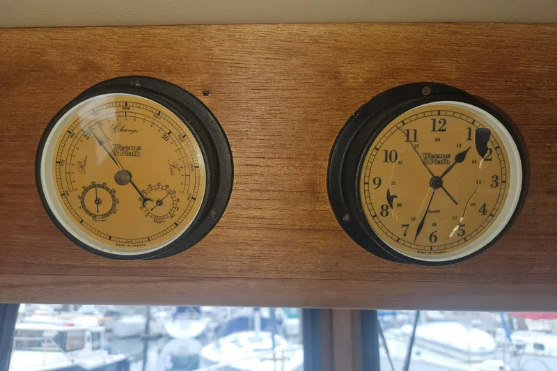 Slide: The Image of Vintage Weems & Plath barometer and clock on 1998 Nordic Tug 32 wooden panel. - 34