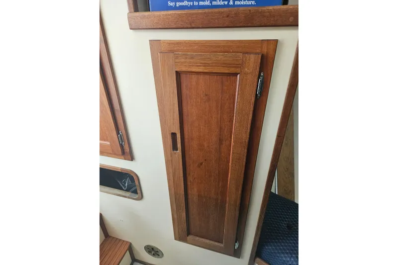 Slide: The Image of Wooden cabinet door inside a 1998 Nordic Tug 32 boat interior. - 37